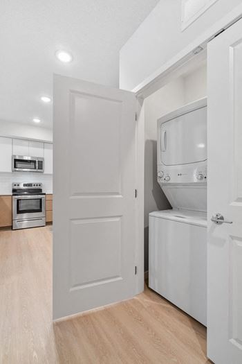 a laundry room with a washer and dryer in a 555 waverly unit at The Aurilla, Cottage Grove, MN, 55016